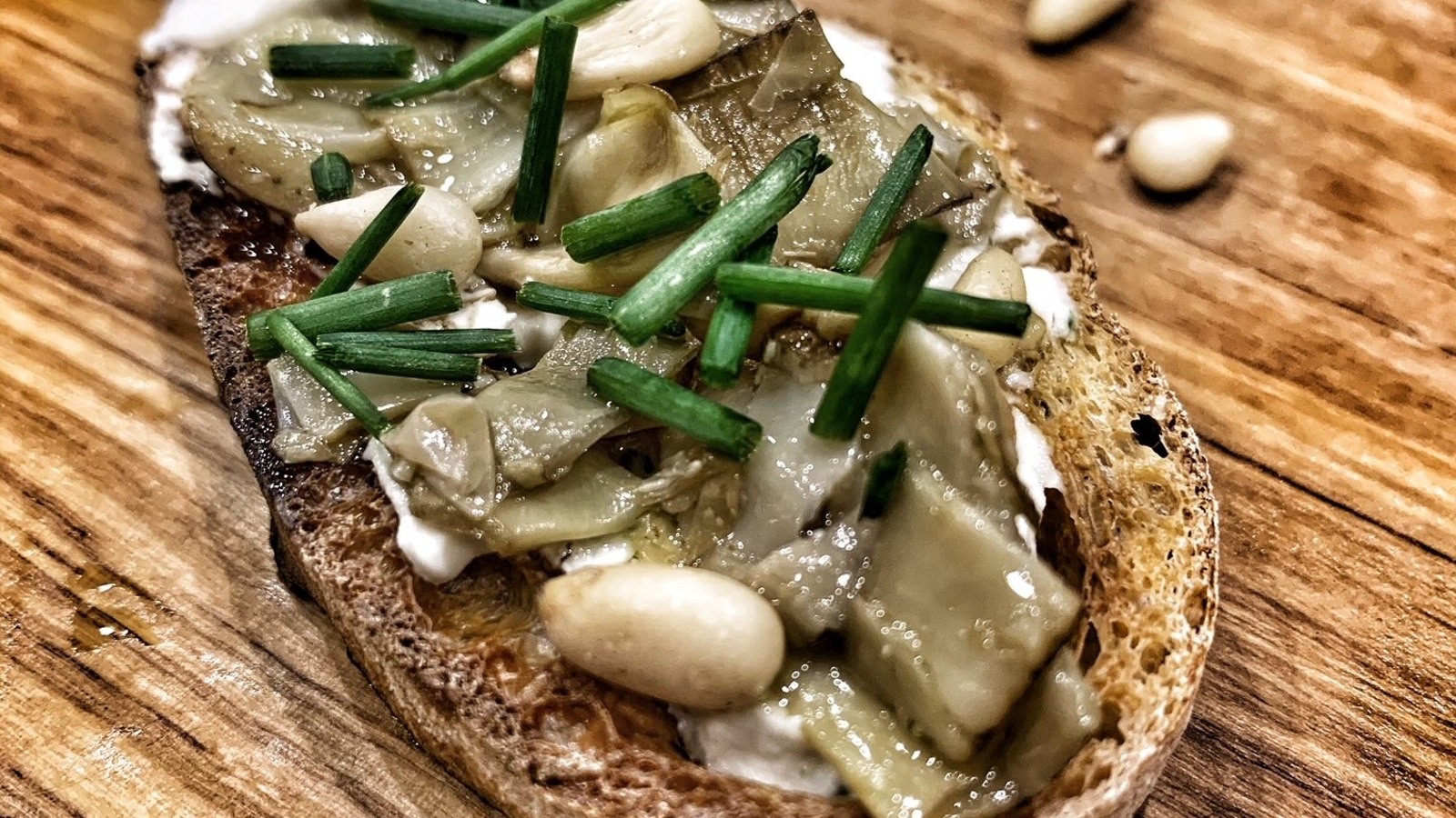 Image of Artichoke Crostini with Cheese and Pine Nuts