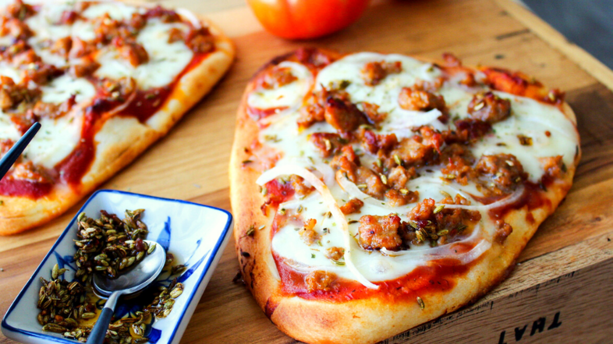 Naan Pizza with Italian Sausage, Toasted Fennel, & Onions