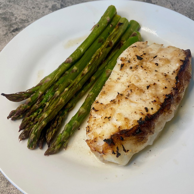 Image of roasted sea bass with asparagus and mojo (citrus garlic sauce)