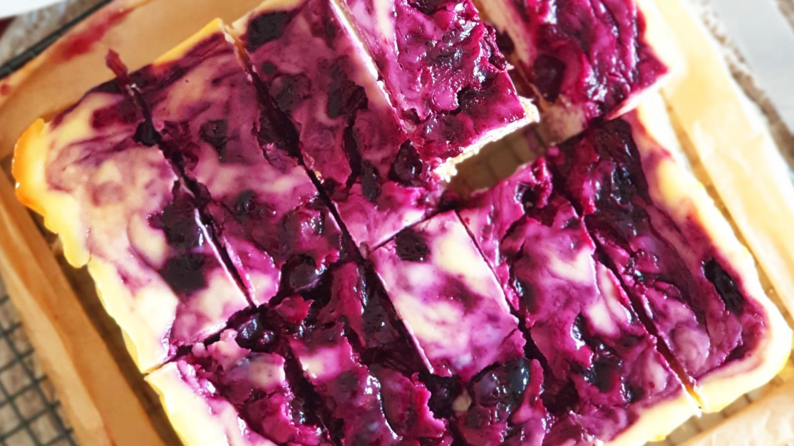 Image of BLUEBERRY AND HASKAP SWIRL CHEESECAKE BARS
