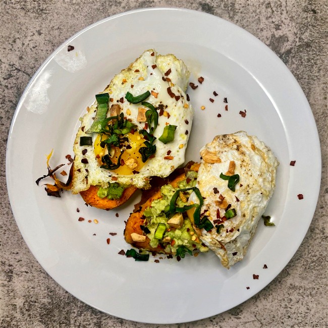 Image of loaded sweet potatoes with guac an eggs