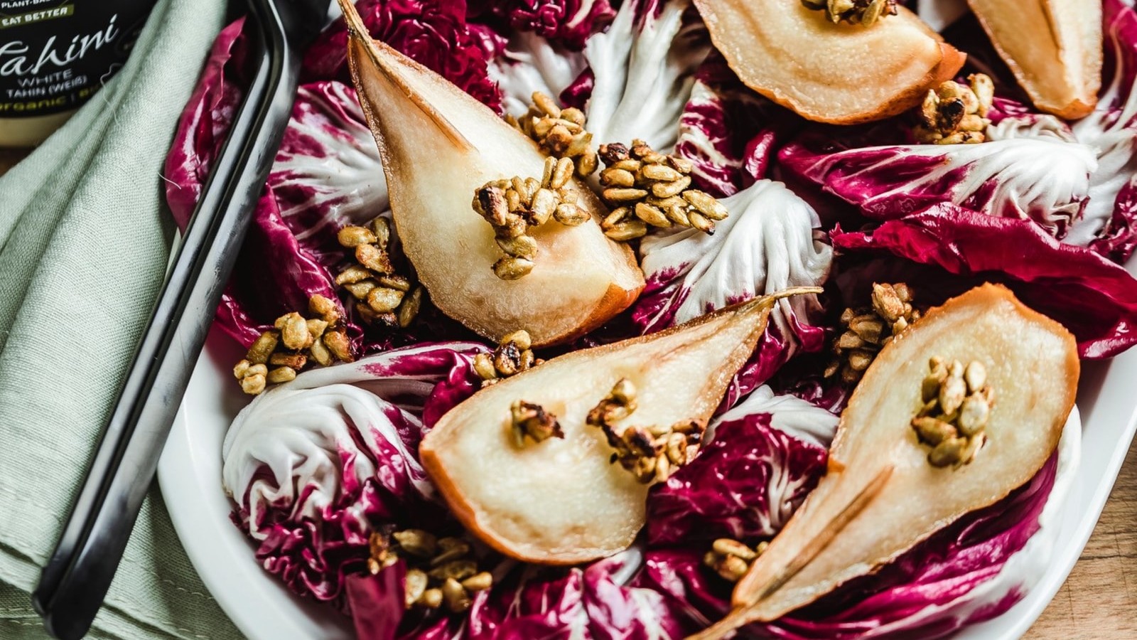 Image of Roasted pear radicchio salad with tahini dressing and sunflower seeds savoury granola